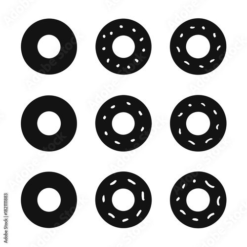 Pattern of nine black donut shapes with varied toppings on white background