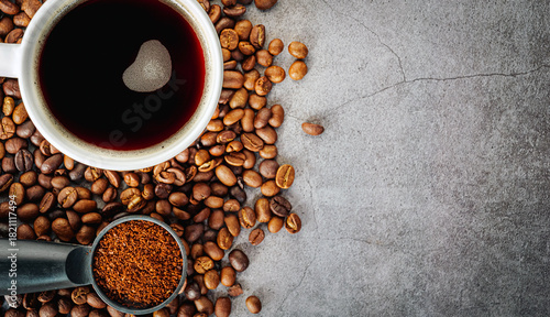 Coffee cup with coffee beans and ground coffee on gray background, Americano cup aromatic top view