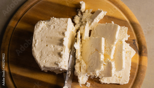 sliced white cheese on wooden cutting board