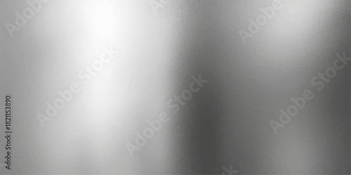 Shiny brushed steel or aluminium metal texture surface with light reflection makes a great metallic pattern backdrop or industrial wallpaper