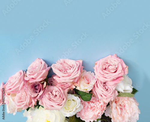 Blooming pink rose flowers bouquet on blue background for Mother's Day