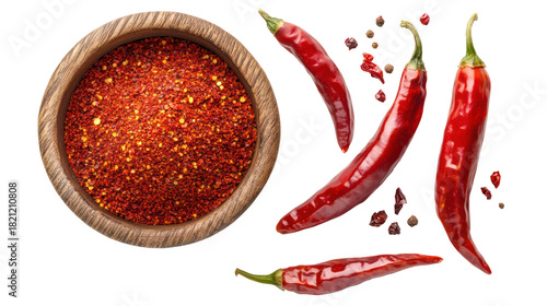 Red chili flakes in a wooden bowl with whole chili peppers isolated on transparent background