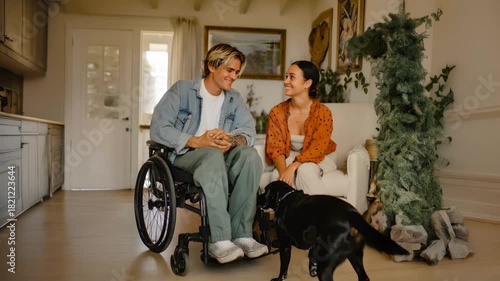 Happy disabled man with girlfriend and dog enjoying time at home