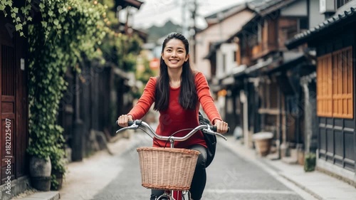 Happy asian woman riding bicycle in old town