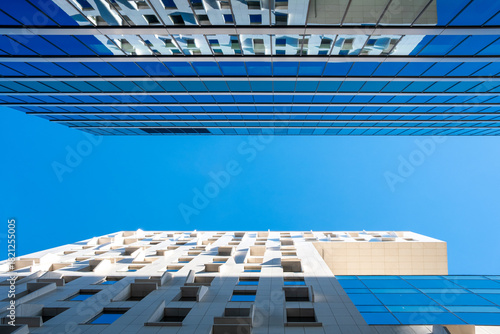 Glass facade structures show modern architecture enhanced by reflections, geometry, office buildings, corporate mood, contrast and clean lines in a strong contemporary look