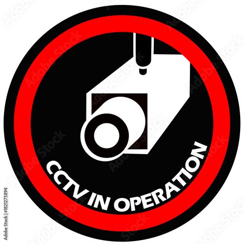 Circular CCTV IN OPERATION warning sign. Bold black, white, and red graphic featuring a surveillance camera icon. Concepts: security, privacy, monitoring, law enforcement, public safety, and restricte