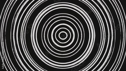 The video begins with a hypnotic sequence of animated concentric circles made of thin, hand-drawn lines. The circles pulse inwards and outwards, creating a mesmerizing effect