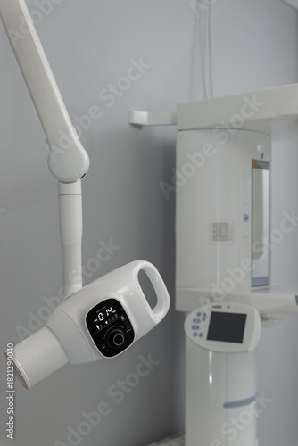 Panoramic X ray and imaging equipment in dental radiology room.