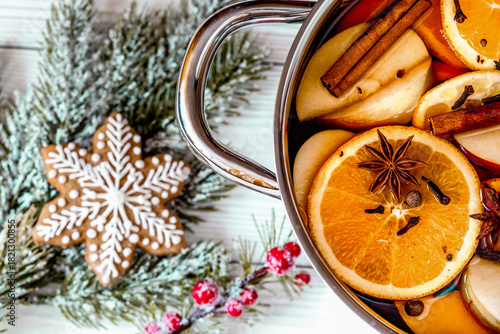 preparation of mulled wine in pot wooden background top view