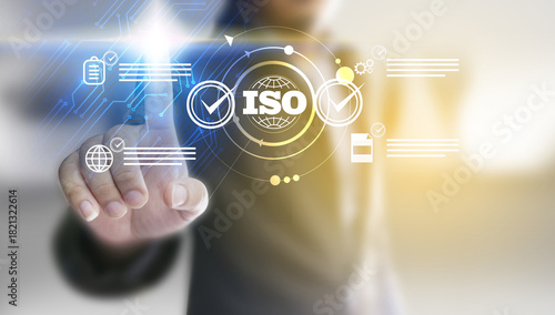 Businessman check quality assurance icon on digital screen with check mark icon for ISO certification and standardization. Quality assurance concept.