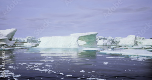 Majestic icebergs drift smoothly in tranquil waters, surrounded by glacial landscapes under a clear blue sky. This serene polar habitat showcases natures beauty and solitude.