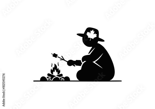 Silhouette of person in hat roasting marshmallow over campfire, with maple leaf on hat