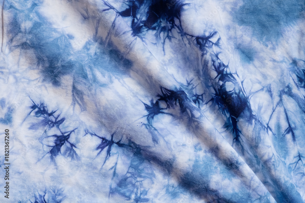 Fototapeta premium Close-up batik shirt with indigo blue dye on white fabric cotton background on top-view