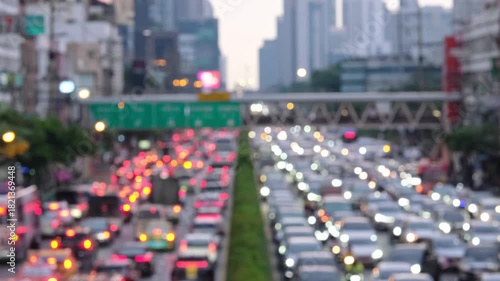 Blurred aerial view from overpass with traffic jam on main road in capital on evening, which is the time rush hour when people get off work