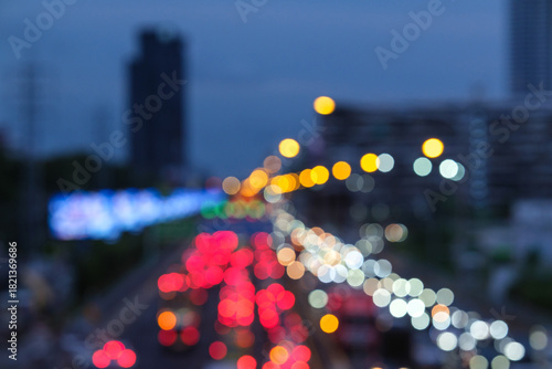 Blurred aerial view from overpass with traffic jam on main road in capital on evening, which is the time rush hour when people get off work