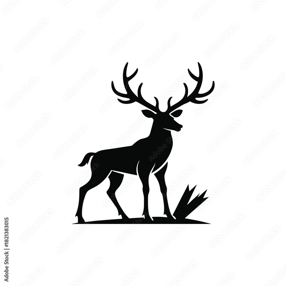 Fototapeta premium Black silhouette of a majestic stag with large antlers standing in grass isolated on white background