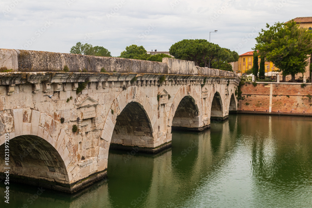 Naklejka premium The Bridge of Tiberius over the Marecchia river in Rimini, Italy