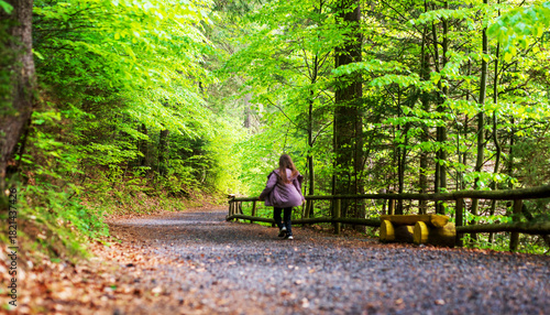 Wallpaper Mural Young girl running on a dirt road in a green forest Torontodigital.ca
