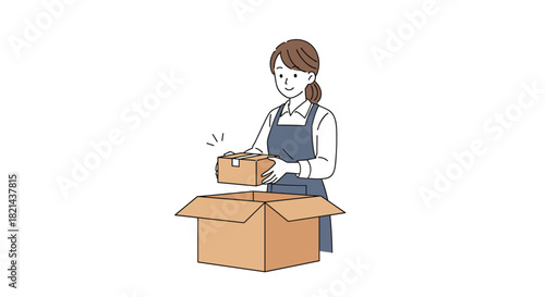 Young woman wearing an apron packing a small box into a larger cardboard box.