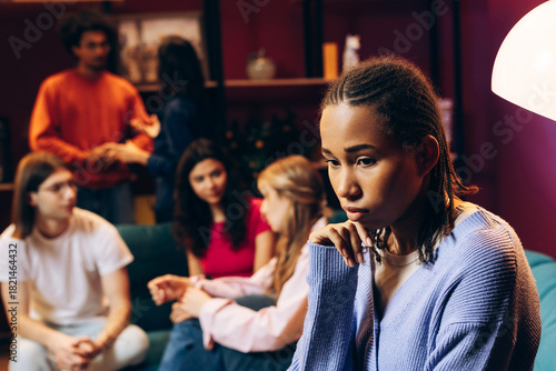Obraz na plátně Young woman feeling isolated and lonely at a social gathering or party