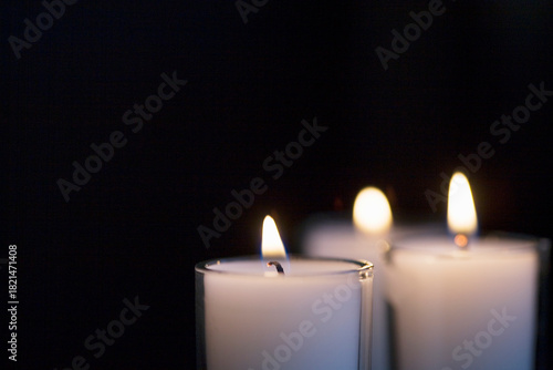 Close-up of votive candles on black background