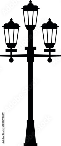 A black and white image of a street light pole with three lights on it