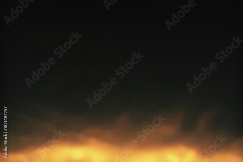 Εκτύπωση καμβά Fiery flames burning against a dark background, the fire's warm glow lights the darkness