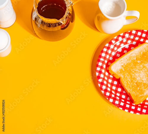 A cozy retro scene featuring a white coffee cup filled with black coffee on a yellow background, accompanied by a glass coffee pot, toasts, egg and a cream pitcher.