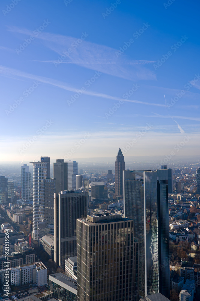 Obraz premium Aerial view of skyscrapers at financial district of German city of Frankfurt seen from Main Tower rooftop on a sunny autumn day. Photo taken November 22nd, 2025, Frankfurt am Main, Germany.