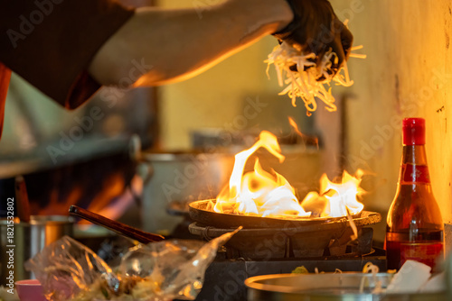 Canvas Print Pad Thai noodles is fried noodles cook in pan with big fire flame is hong kong style