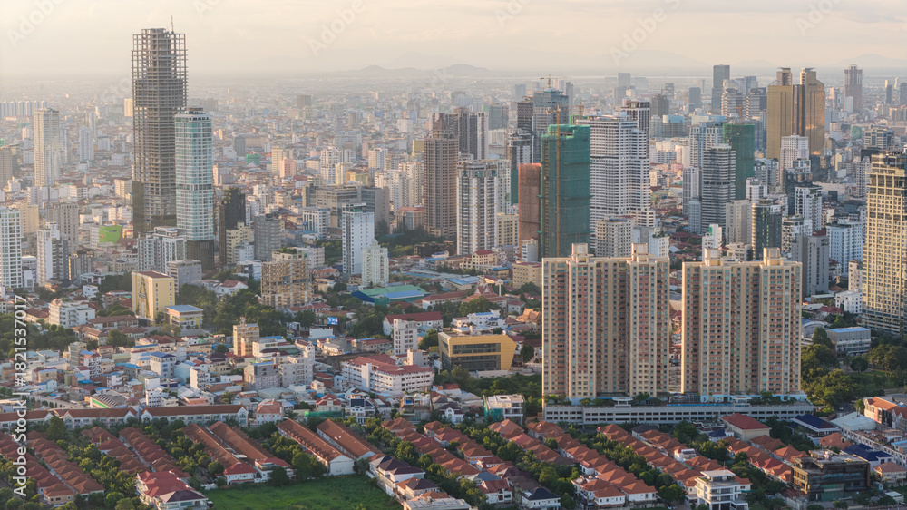 Naklejka premium Modern residential areas and office buildings with Tonle Sap river in the background in rapidly developing Phnom Penh city panorama, Cambodia