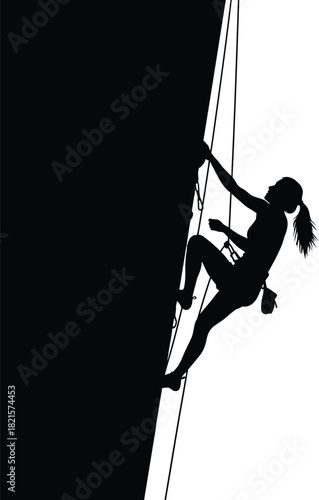 Silhouette of a woman rock climbing on a cliff