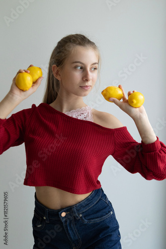 girl holding fresh lemons on light background healthy eating concept