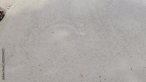 Draw a heart on the wet sand with footprints on the left side of the heart. The heart and footprints were washed away by the waves. Unrequited love. Lost love.
