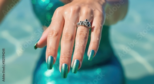 Sparkling mermaid core nail design and ocean inspired ring create magical allure and seaside fantasy for summer beauty looks
