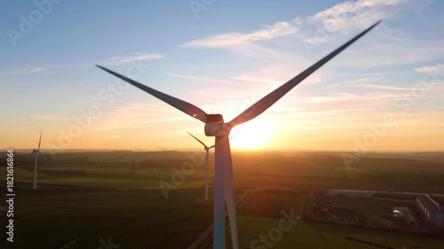 Close up aerial view of wind turbines electrical energy generation evening winter sunset golden light near Newmarket, UK