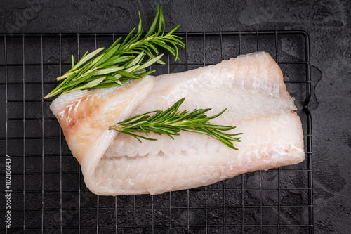 Slika na platnu Uncooked Atlantic cod fillet, raw fish ready to be seasoned and transformed into a delicious meal