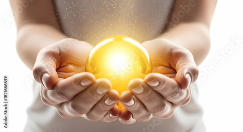 Glowing golden orb held gently in human hands, radiating light and magic, perfect for concepts of hope, inspiration, potential, and future possibilities