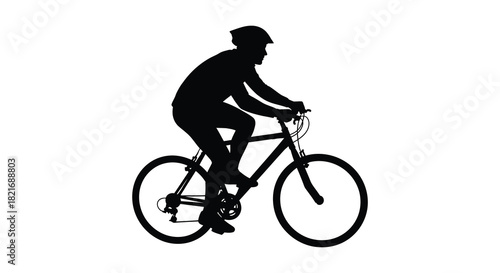 A cyclist riding a mountain bike in a stark black silhouette