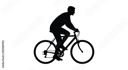 A cyclist riding a bicycle shown in a dark striking silhouette