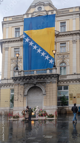 Bosnian flag and wreaths around  Eternal flame for  Statehood Day