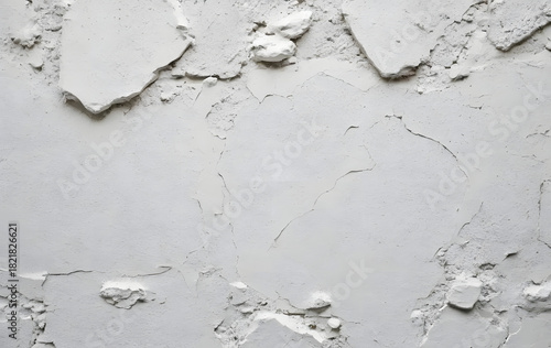 Photo of a detailed texture of a white wall with a natural cracked surface texture.