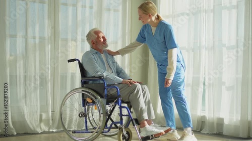 Help support retirement healthcare. Nurse helping old man in wheelchair. Patient and woman in nursing home for medical caregiver. Nurse taking care of paralyzed man in chair for people with disability
