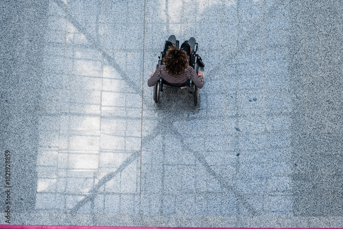 Top View Of a Person In Wheelchair On Floor, Accessibility And Inclusion Concept Disability Awareness.