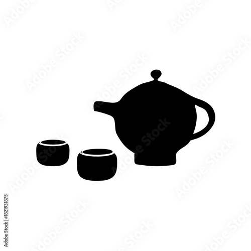 Traditional white porcelain teapot and teacup set isolated on brown ceramic kitchen counter