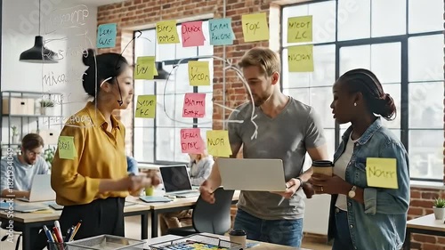 Diverse team of creative professionals in a dynamic brainstorming session, collaborating on a new business strategy using sticky notes and a laptop