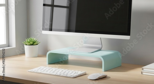 Modern workspace setup features a computer display elevated on a pastel riser next to a small houseplant