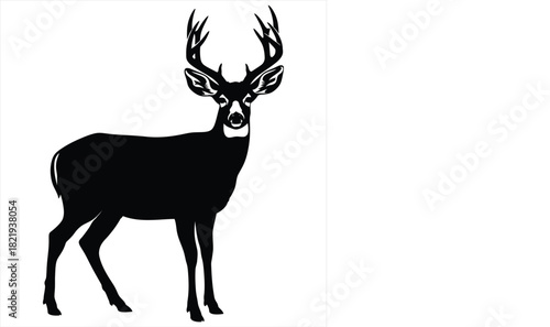 Black silhouette of a majestic buck with large antlers standing tall