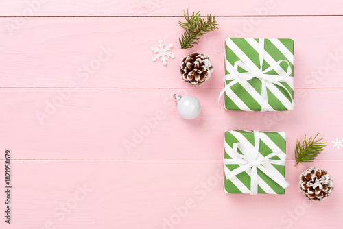 Striped Christmas gift boxes on wooden background, top view