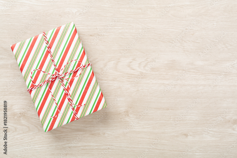 Obraz premium Striped Christmas gift boxes on wooden background, top view
